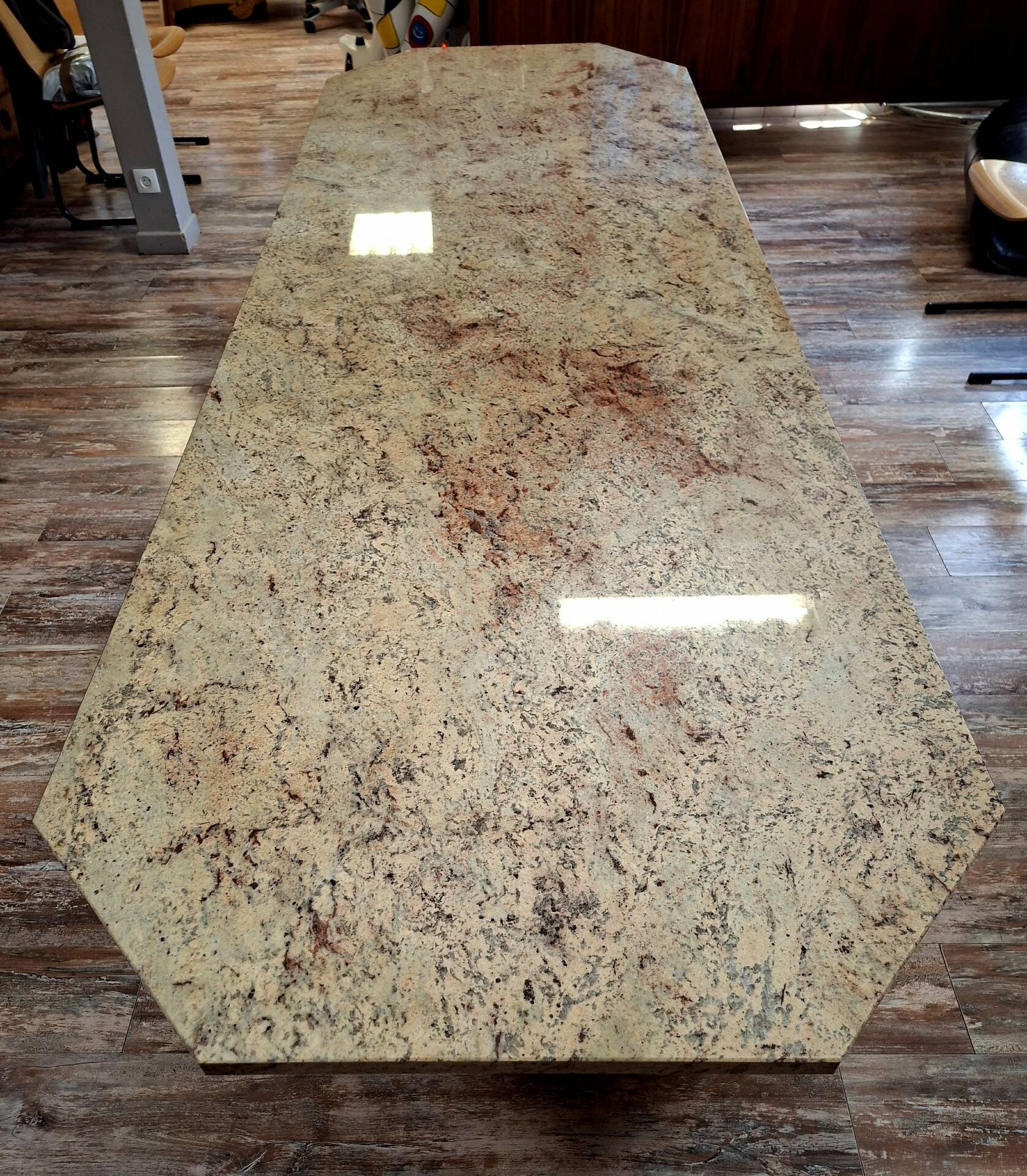 Large polished granite dining table on an oak and iron base.