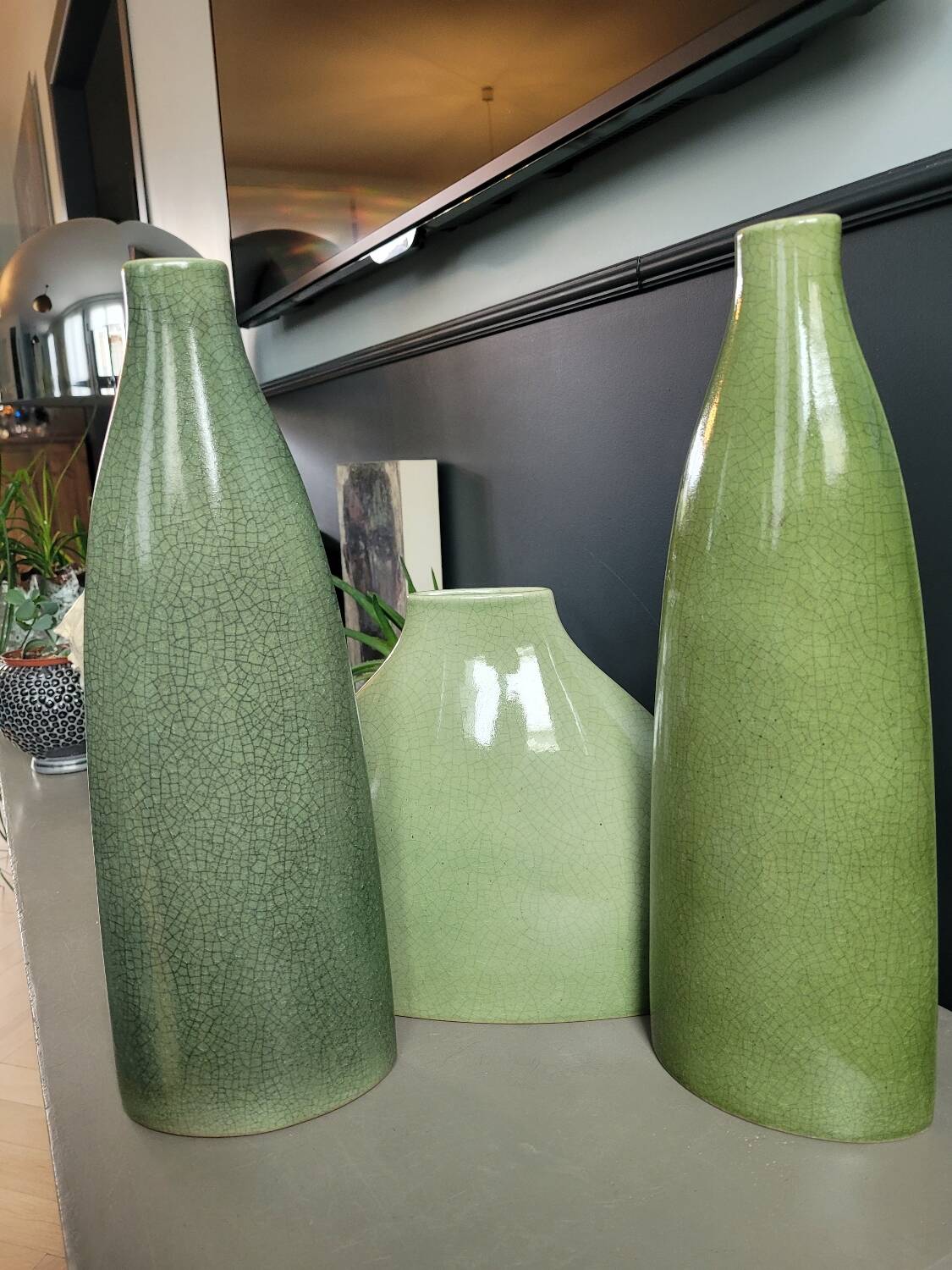 Trio of green enamelled vases