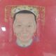 A framed Chinese ancestral portrait is a traditional hand-painted