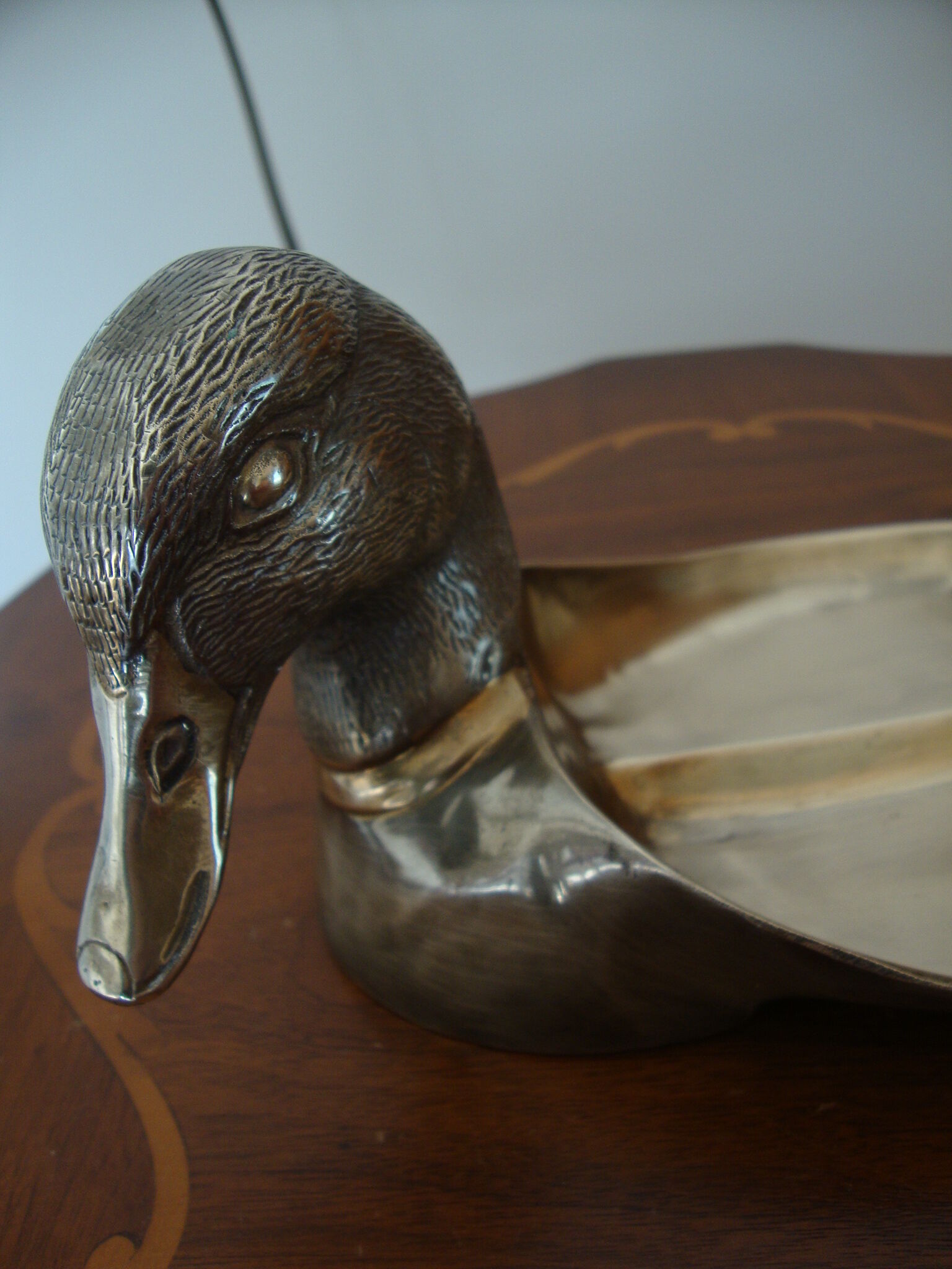 Empty pocketed old duck in solid brass
