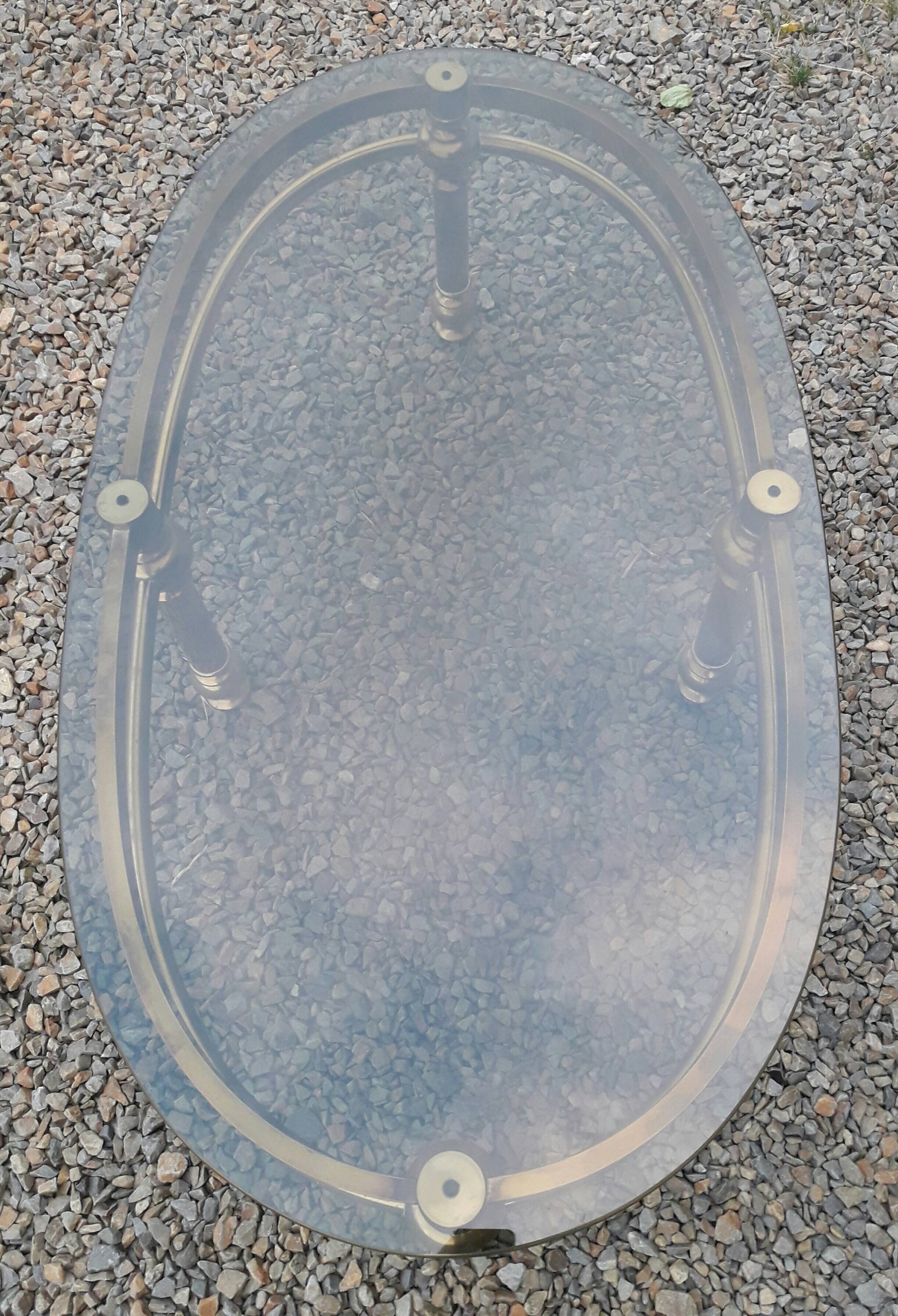 Oval coffee table in gilded brass and smoked glass 1970