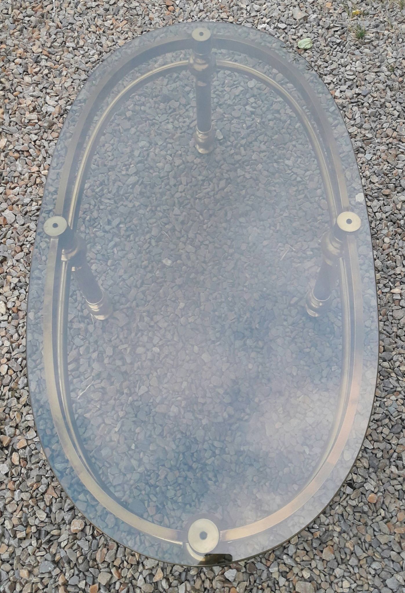 Oval coffee table in gilded brass and smoked glass 1970