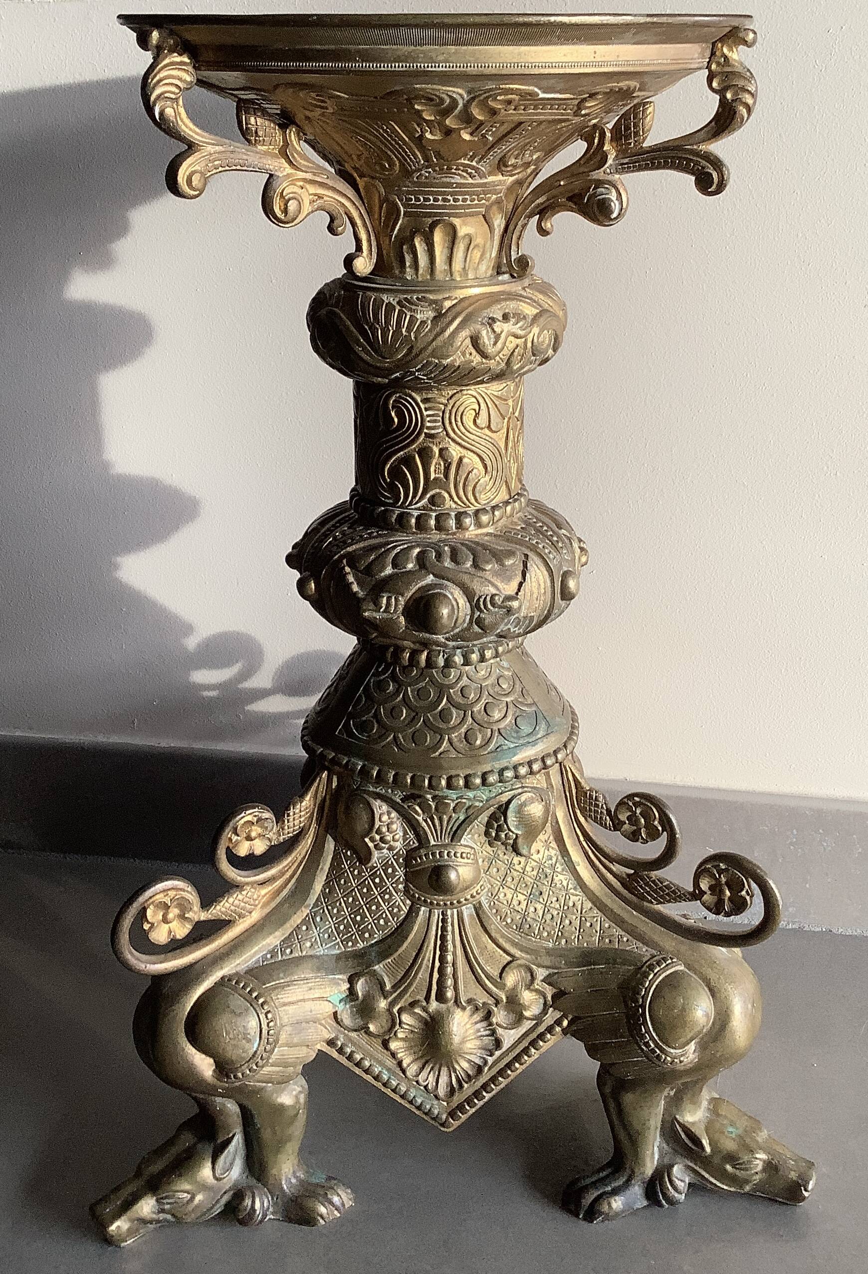 Large bronze candlestick with tripod and winged dog decoration, 19th century.