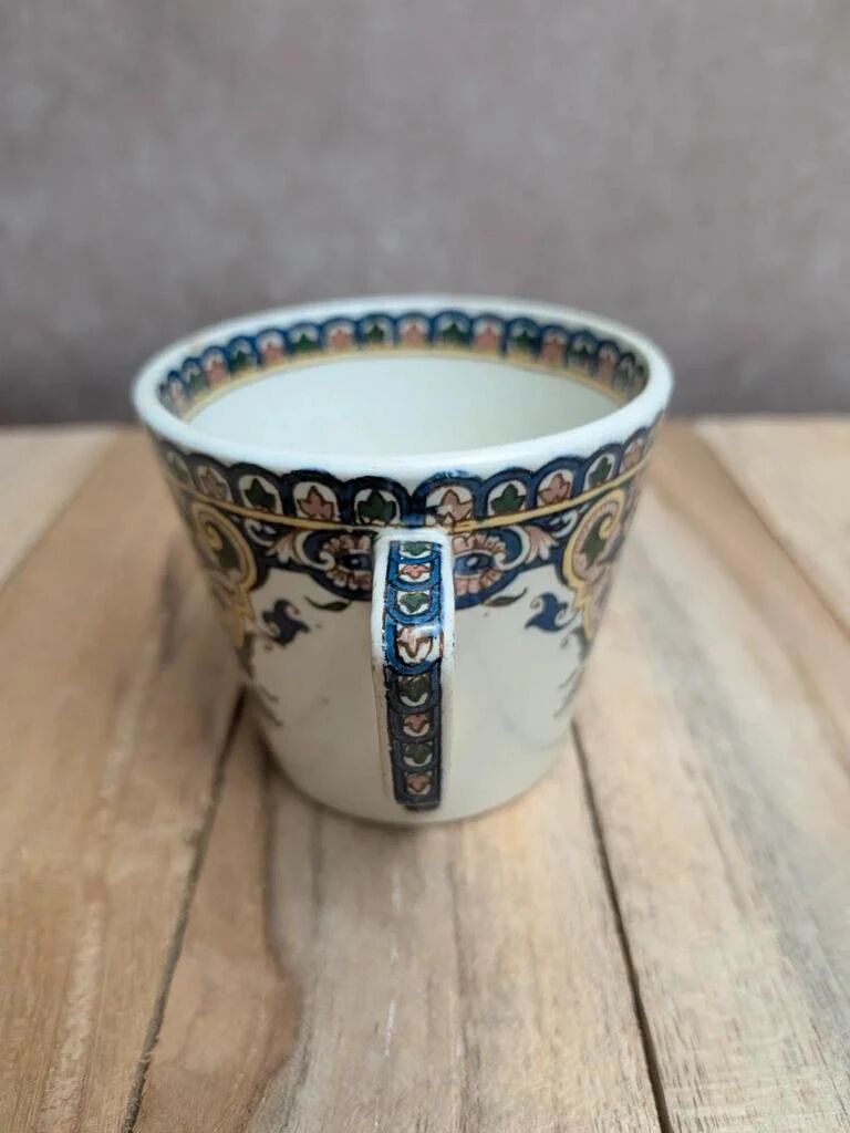 Antique ironstone cup from Sarreguemines with polychrome decoration.