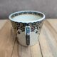 Antique ironstone cup from Sarreguemines with polychrome decoration.