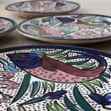 4 colorful flat plates with a fish pattern