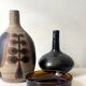 Glazed black ceramic vase with a single stem, signed, circa 1950.