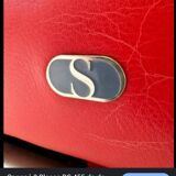 RED LEATHER ARMCHAIRS signed “SEDE”