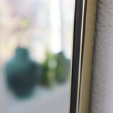 '50s wall mirror with relief brass frame
