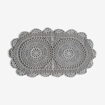 Old oval handmade crochet doily in the old-fashioned cotton embroidered with 2 centers
