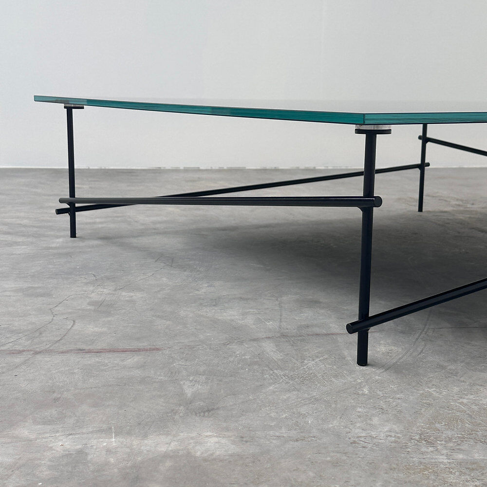 Minimalist black glass coffee table with industrial metal base
