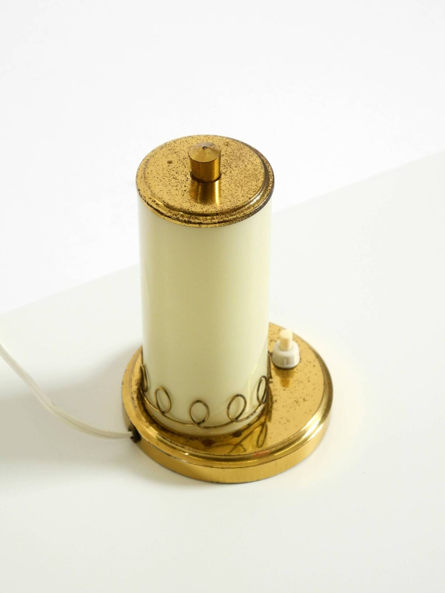 A beautiful, rare 1950s brass table lamp with one opal glass shade adorned
