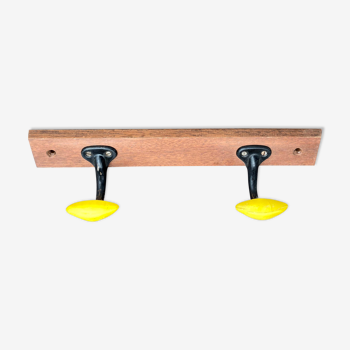 Coat rack with 2 yellow and black hooks