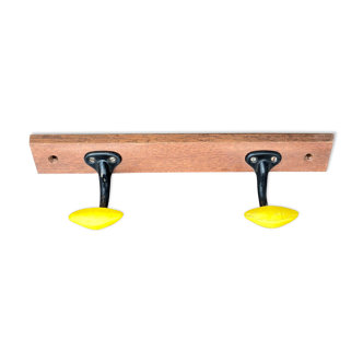 Coat rack with 2 yellow and black hooks