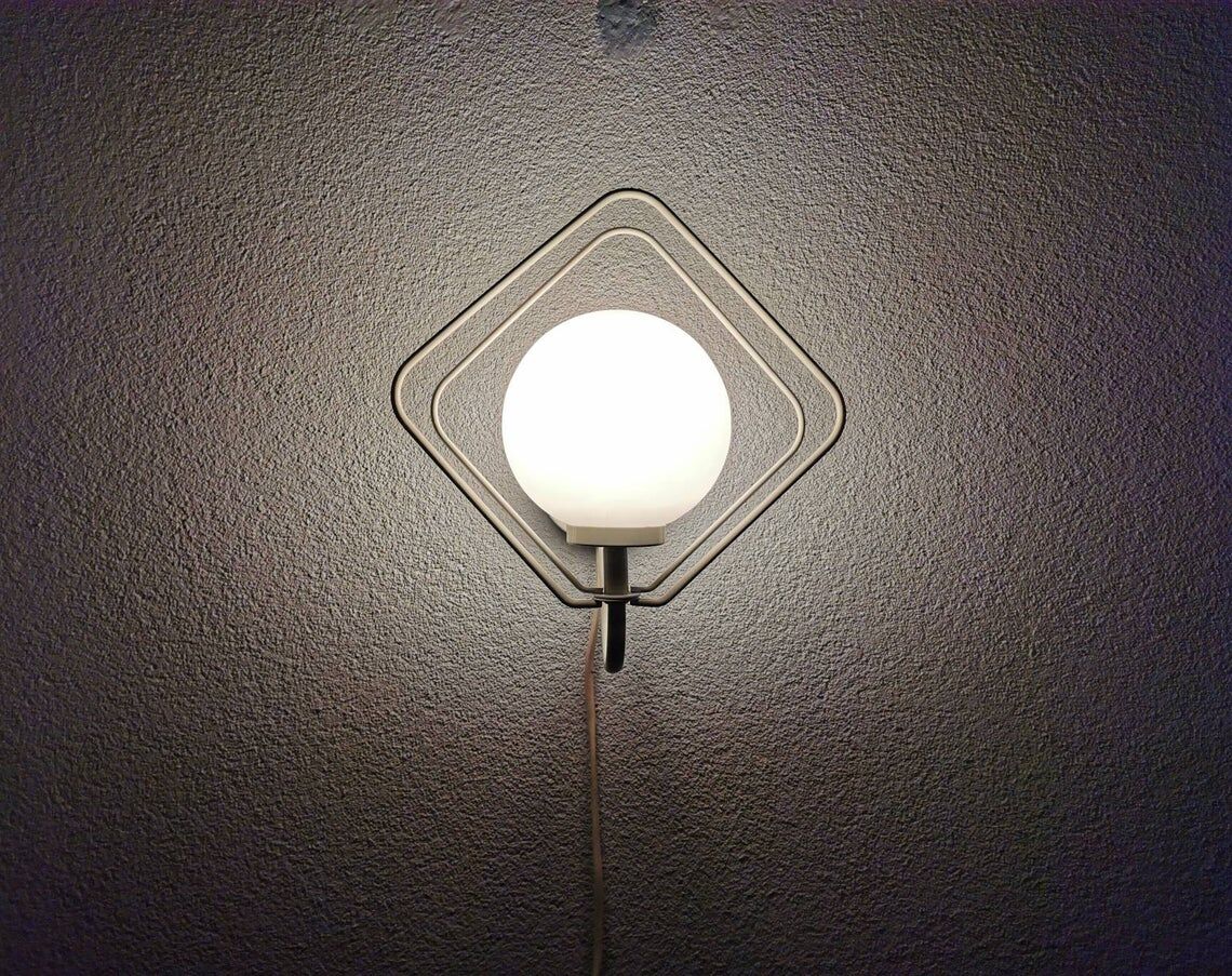 Metal applique with 80s glass sphere