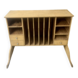 On a piece of furniture with sorting lockers and drawers