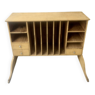 On a piece of furniture with sorting lockers and drawers