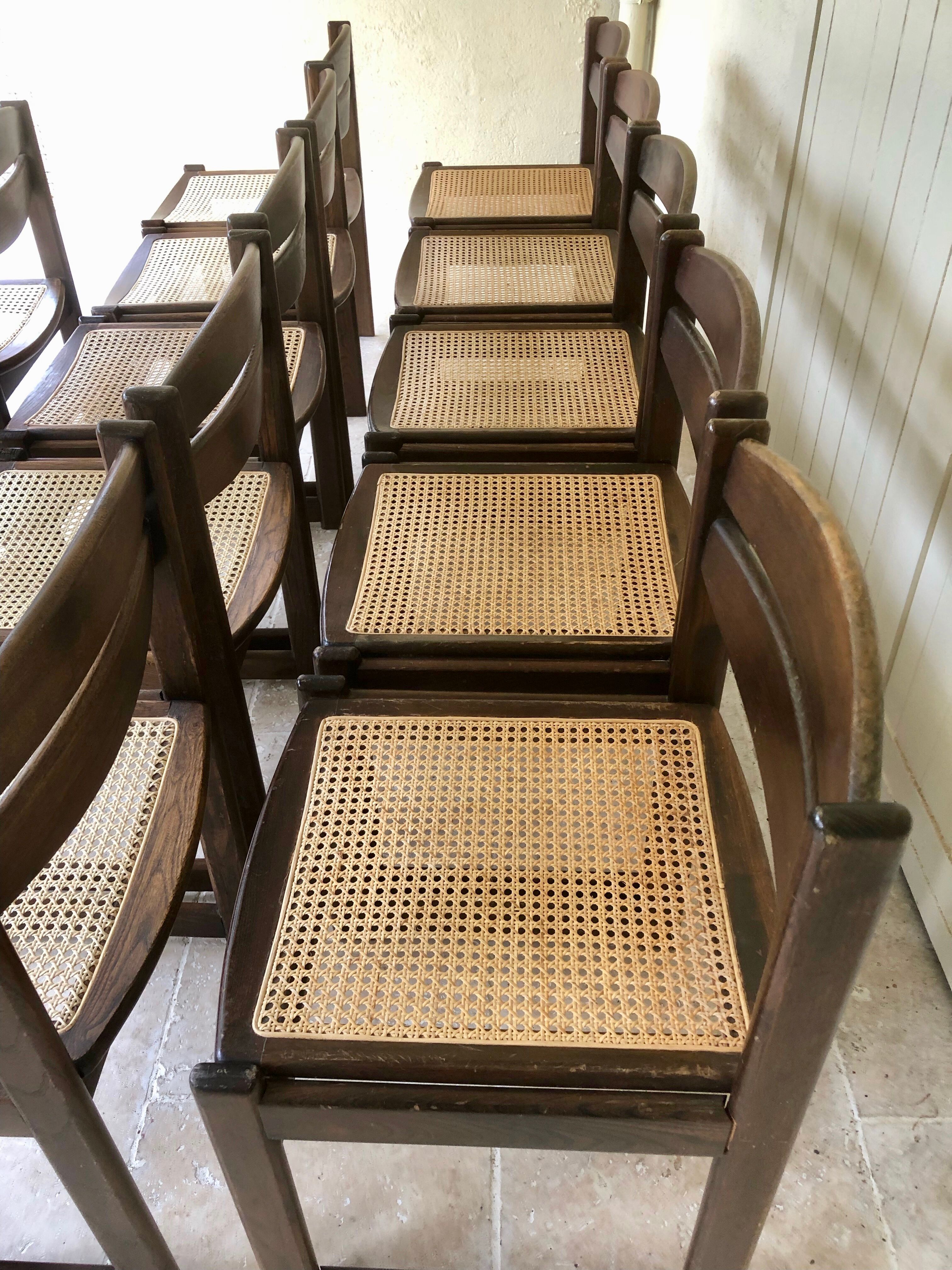 Set of 12 "sledge" dining chairs in walnut and cane.