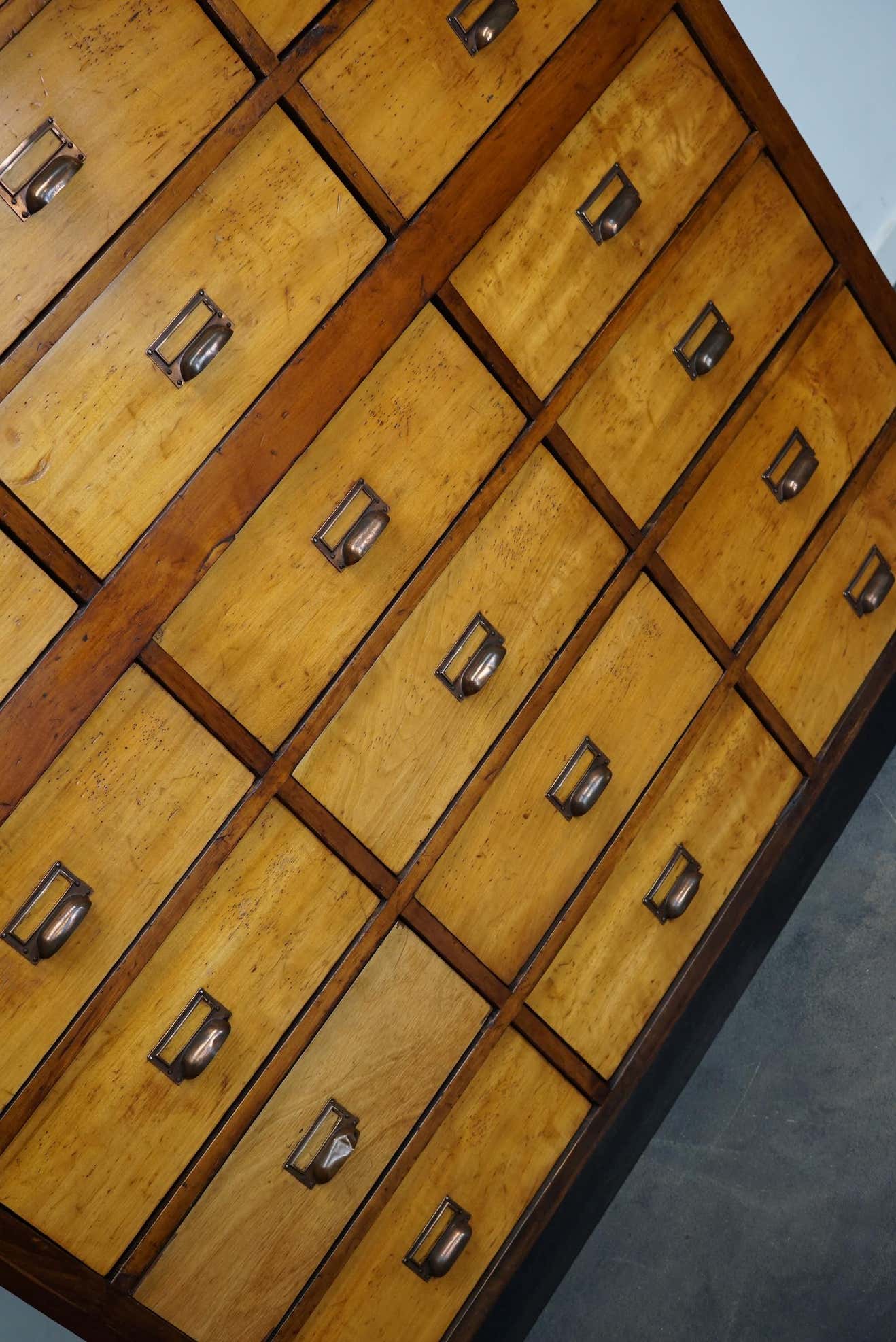 School cabinet bank of vintage Dutch drawers in mid-twentieth century pine