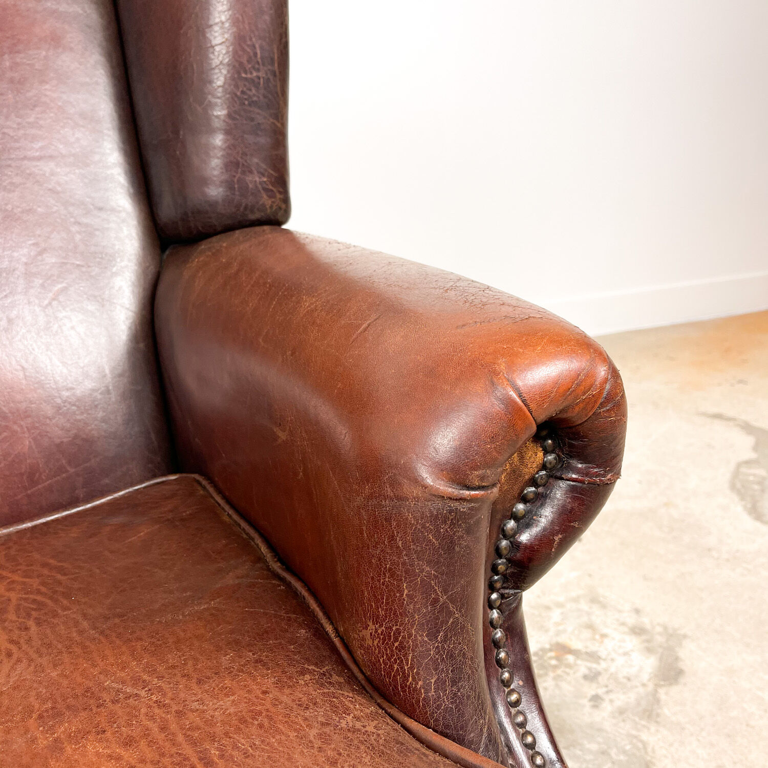 Dark brown vintage sheep leather wingback armchair