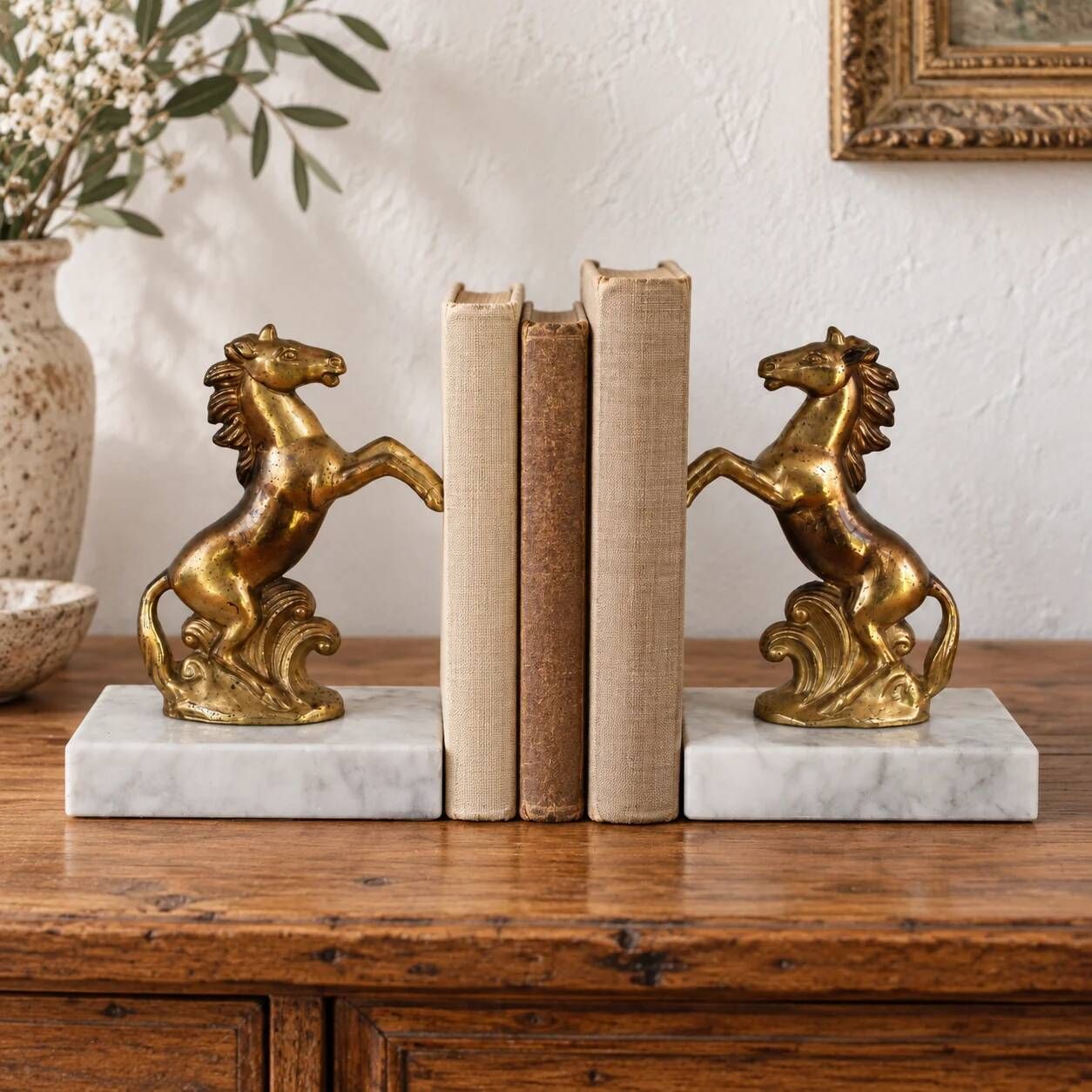 Pair of vintage bookends with rearing horses in gilded metal on marble bases.