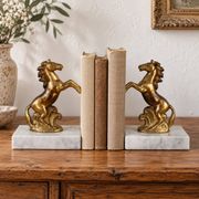 Pair of vintage bookends with rearing horses in gilded metal on marble bases.