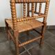 Old armchair, corner chair, made of wood and straw