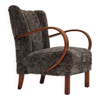 Années 1950, design danois, fauteuil retapissé, véritable peau de mouton "Wellington".