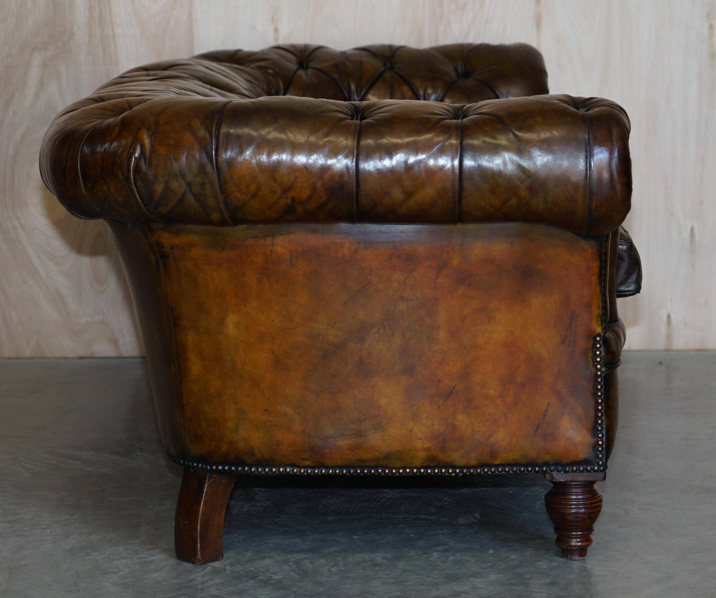 Victorian Chesterfield leather upholstered canapé with feather cushions.