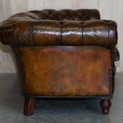Victorian Chesterfield leather upholstered canapé with feather cushions.