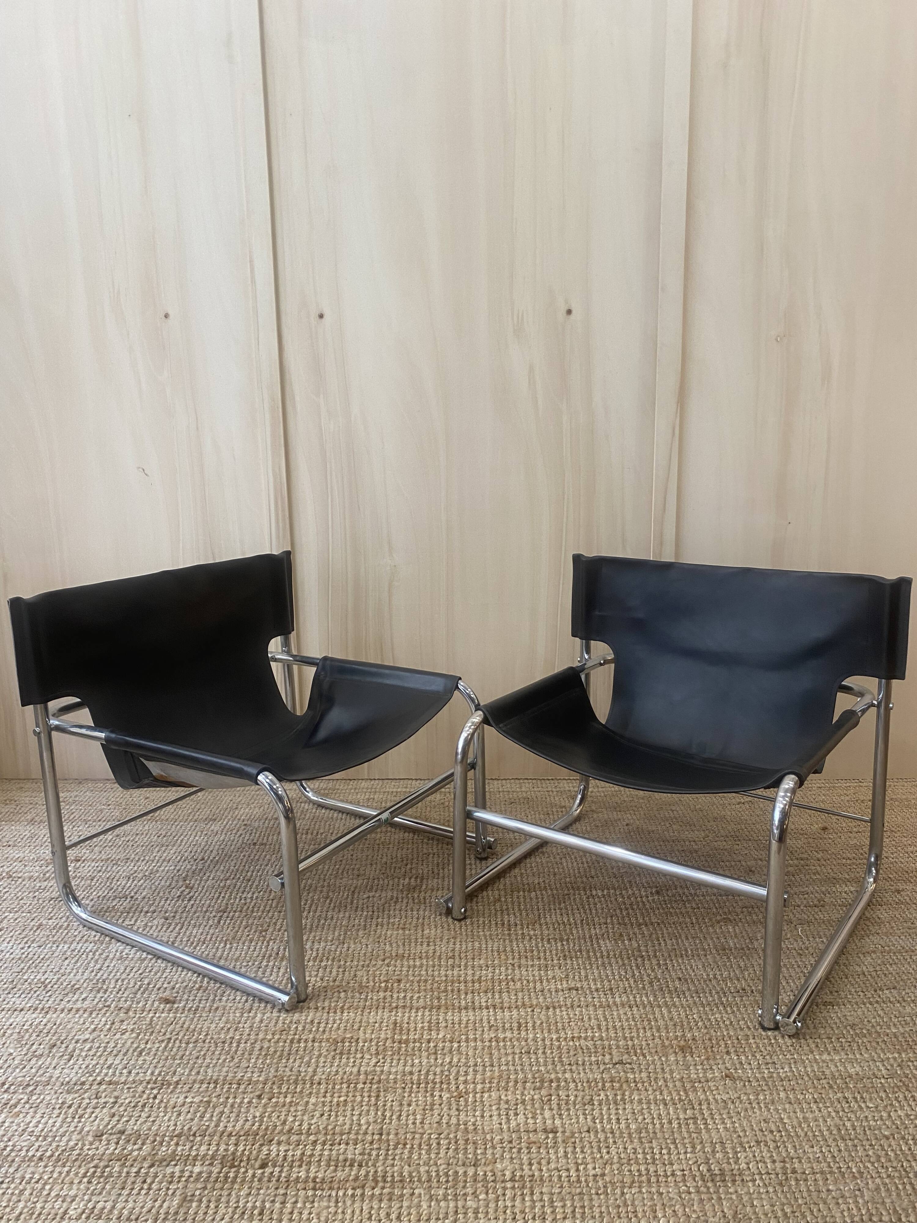 Black leather armchairs with a metal frame by Rodney Kinsman.