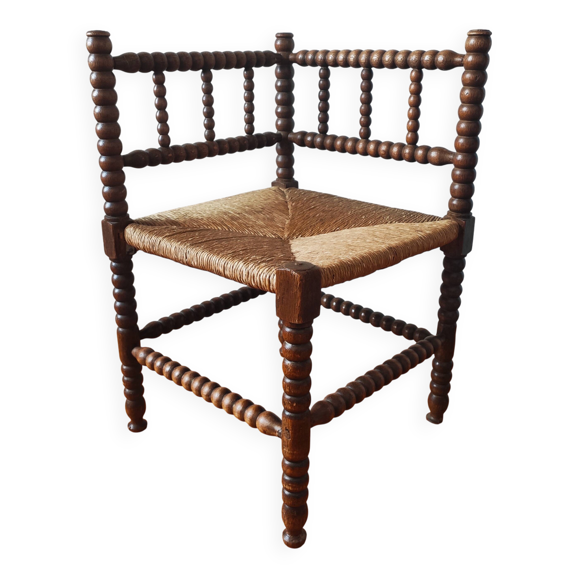 Antique corner chair made of turned wood spindle.