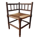 Antique corner chair made of turned wood spindle.