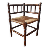Antique corner chair made of turned wood spindle.