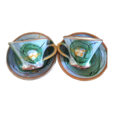 Two cups and their hand-painted ceramic saucer
