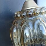 Suspension in molded glass golden reflection