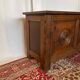 Small antique oak chest with carved panels.