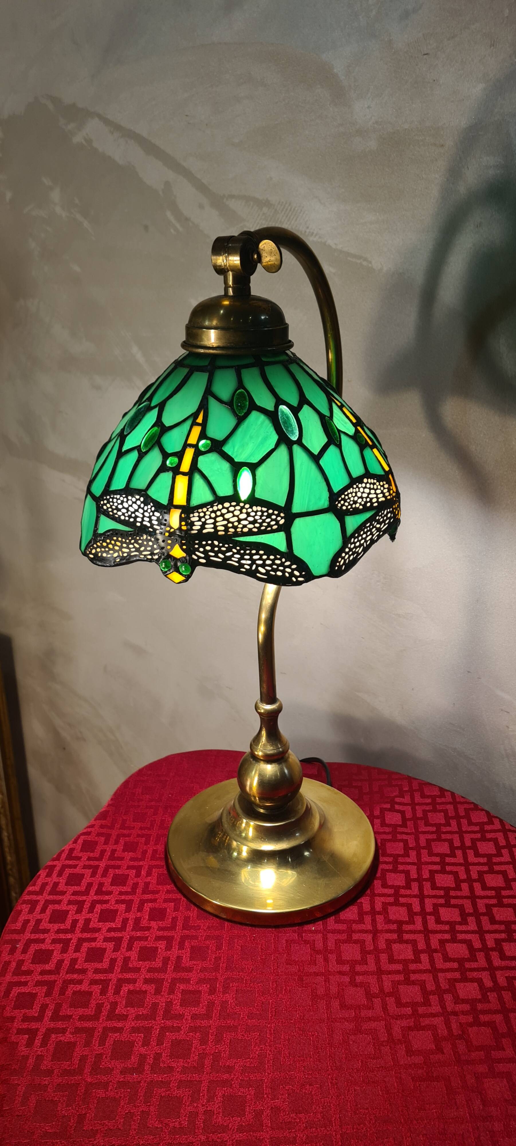brass lamp with green stained glass shade.