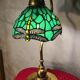 brass lamp with green stained glass shade.