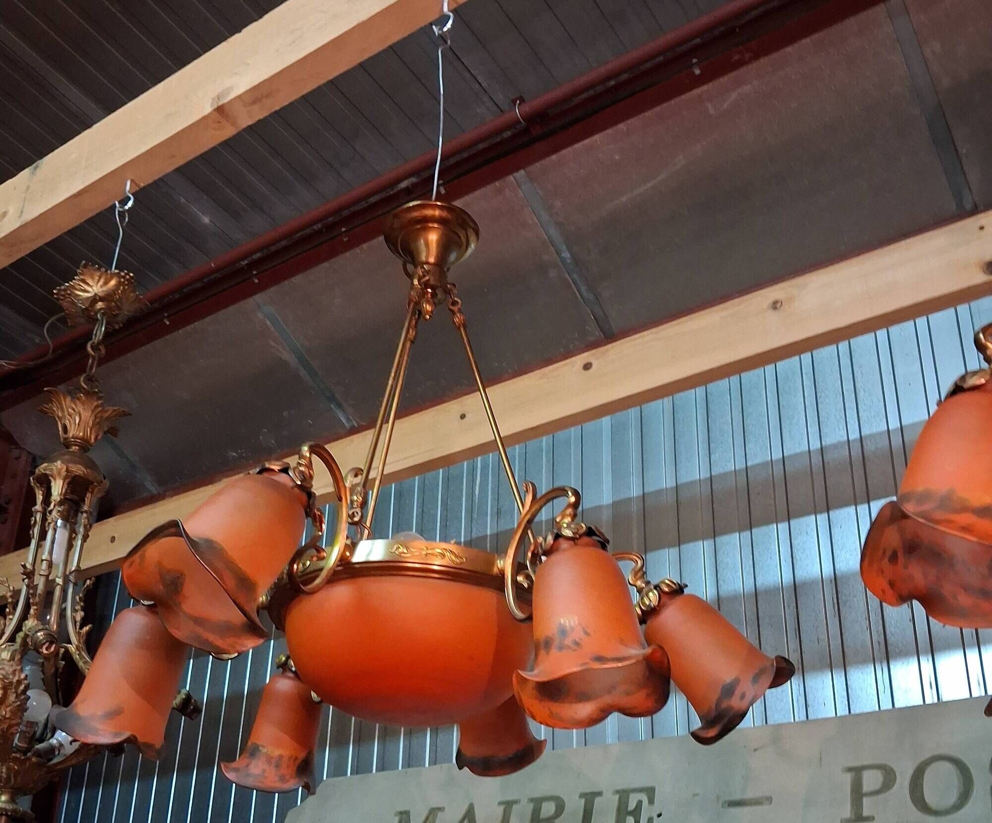 Pair of Art Nouveau style chandeliers in bronze and orange glass paste.