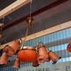 Pair of Art Nouveau style chandeliers in bronze and orange glass paste.