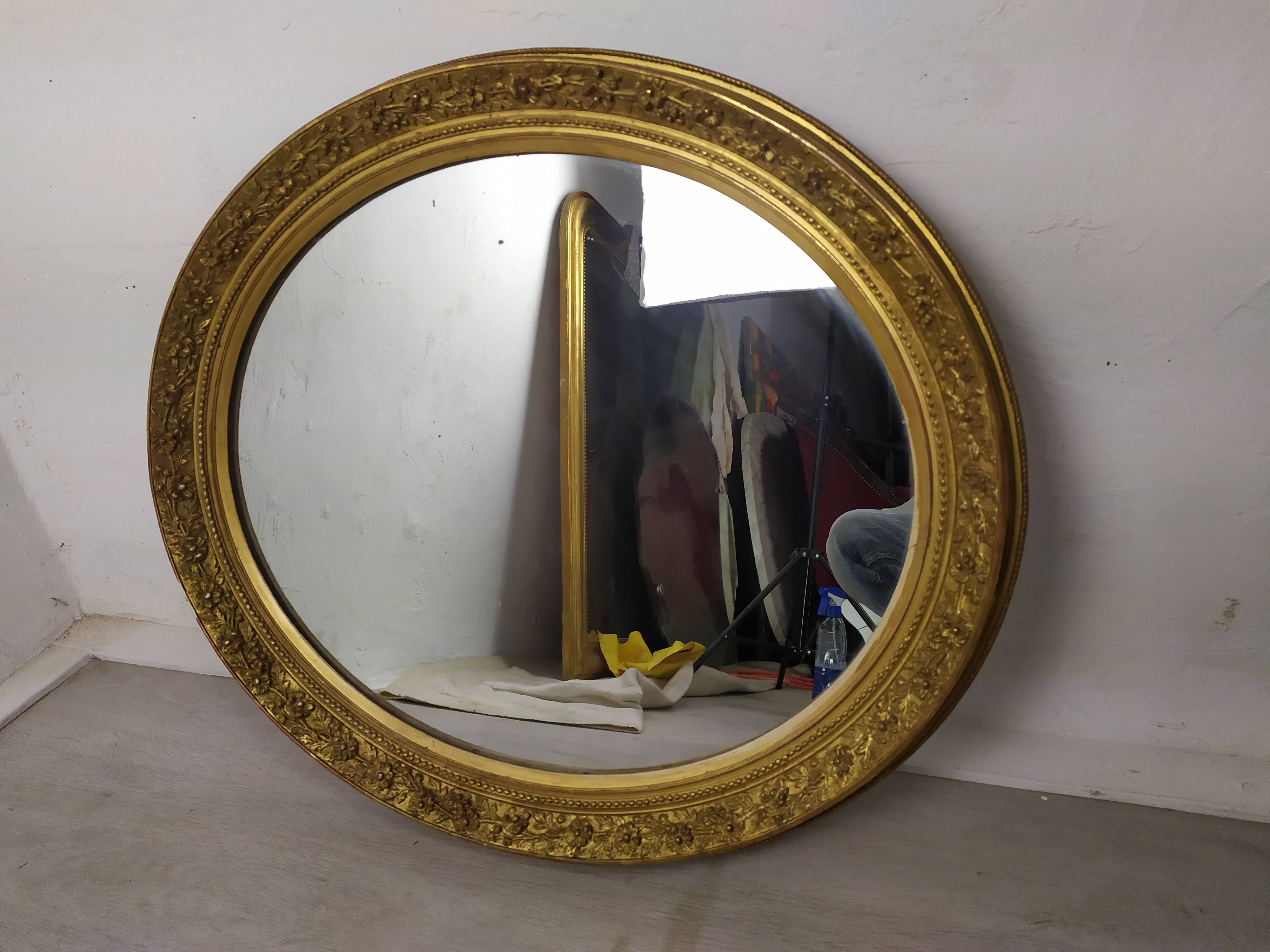 Golden oval mirror