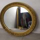 Golden oval mirror