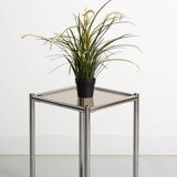 Bolster or end table in chrome steel with smoked window.