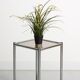 Bolster or end table in chrome steel with smoked window.