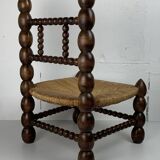 Brutalist wood turned bobbin low rush chair in the style of Charles Dudouyt