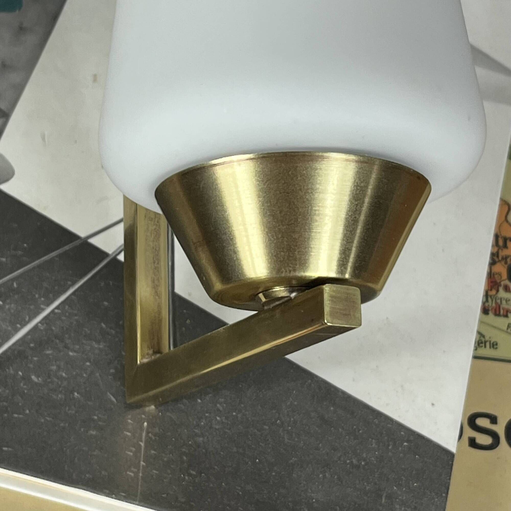 Vintage brass wall light with a white glass spindle shade from the 1950s-1960s.