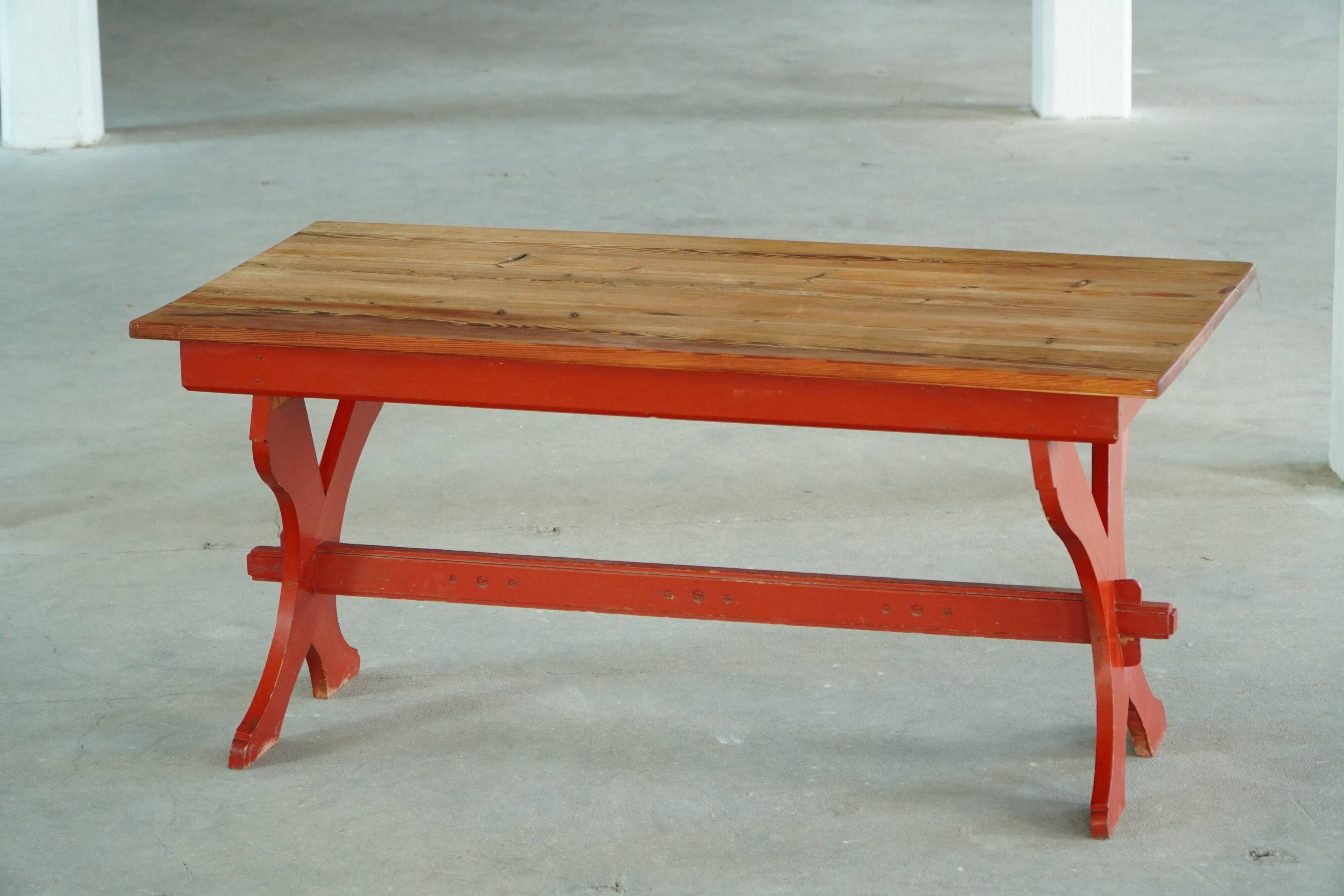 Rustic farmhouse dining table in painted red pine, Sweden, 1920s.