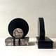 Art Deco bookends with a circular design in black and pink marble.