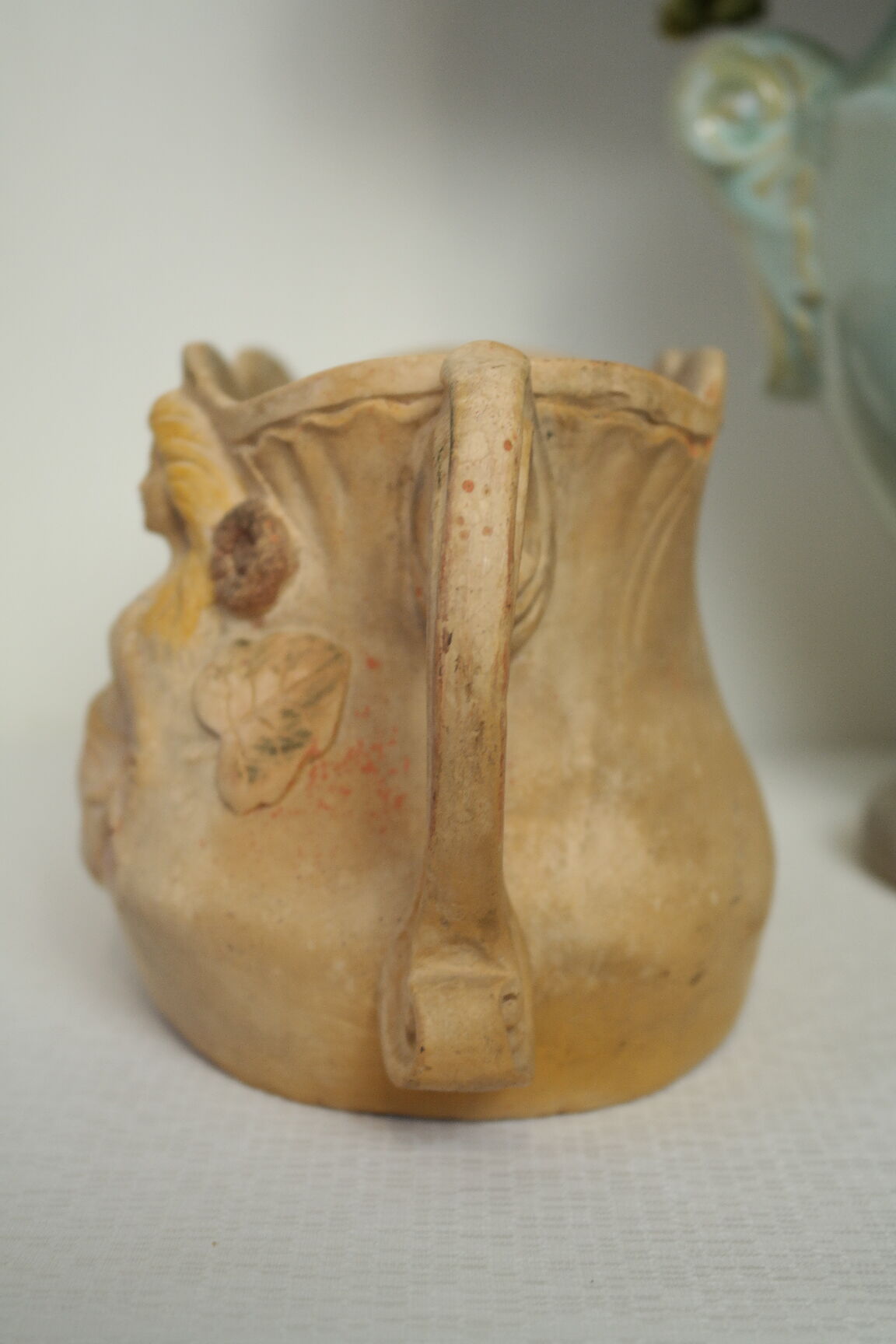 Art Nouveau jardinière with bas-reliefs in terracotta.